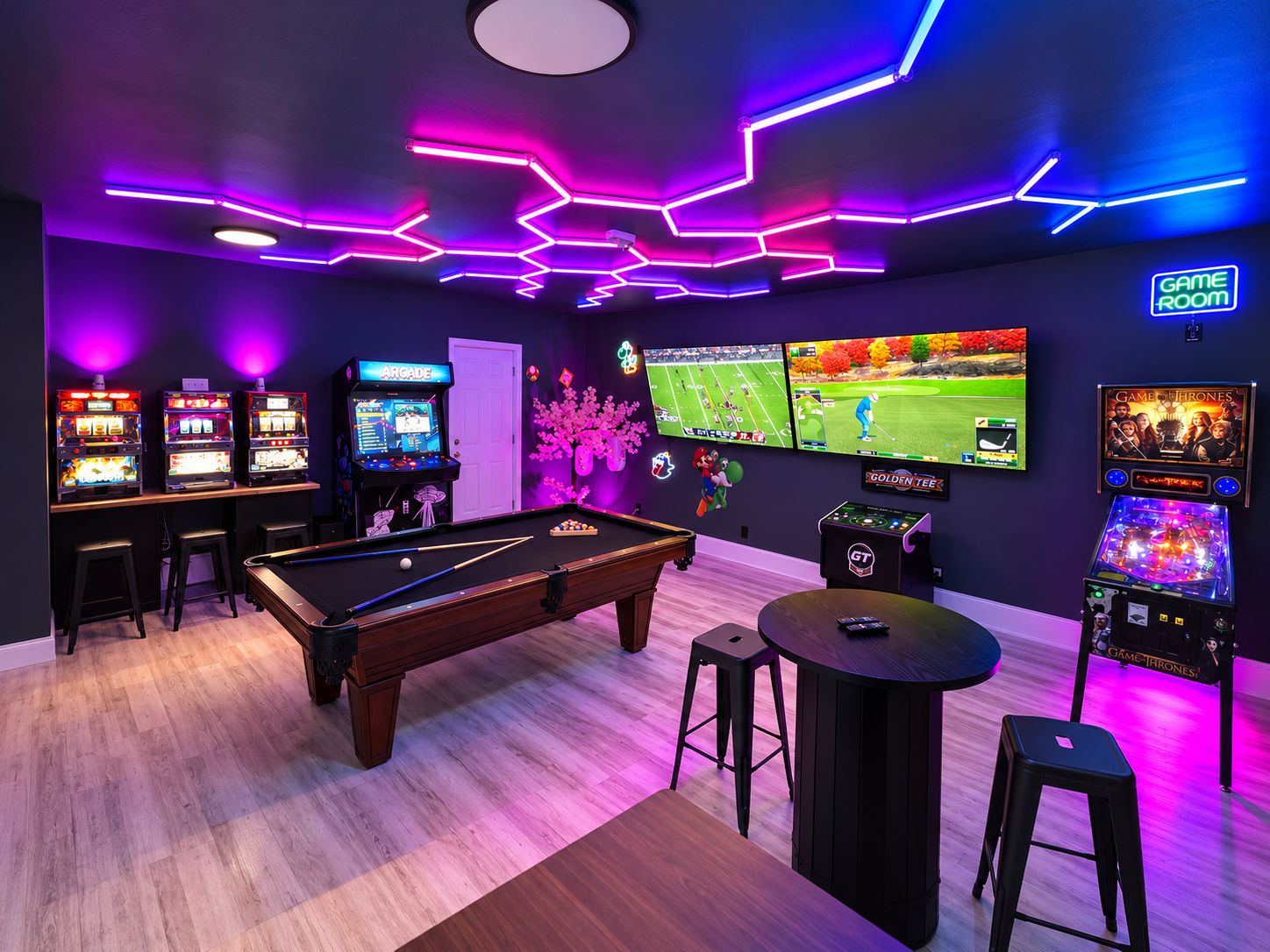 A room with a pool table, arcade games, and multiple screens displaying video games.