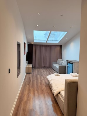 A modern bedroom with a skylight, a bed, a sofa, and a wardrobe. - Rich Area In Istanbul Residence 4 (Istanbul)