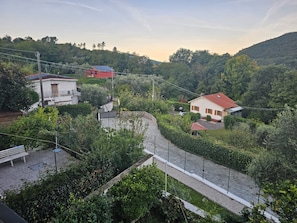 A residential area with houses, a paved pathway, and a fenced garden. - A unique and charming attic apartment, thoughtfully designed and fully equipped (Piazza)