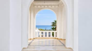 Un pasillo con vistas al mar y palmeras.