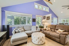 A living room with a sectional sofa, ottoman, and a dining area with a table and chairs. - SUNDANCE FILM FESTIVAL LUXURY HOME RENTAL!!! (Niwot)