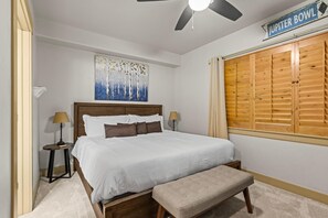 Unwind in your serene bedroom, where plush linens and coastal charm create the perfect escape. Natural light filters through wood shutters, inviting peaceful rest after your day of adventure. - Steps to Hot Tub, King Suite, Free Shuttle, Gas Fireplace | Moose Mgmt 4206 (Park City)