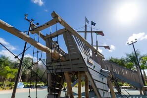 A large wooden structure with a sloped roof, possibly a play area or exhibit, with ropes and a flagpole. - Villa Smile - 4bd/3ba Storey Lake Luxury Themed (Kissimmee)