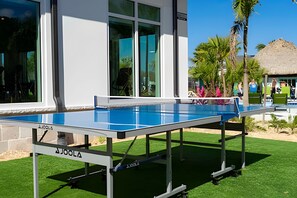 A pool table set up outdoors with a building in the background. - Villa Smile - 4bd/3ba Storey Lake Luxury Themed (Kissimmee)