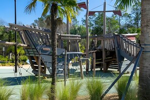 A playground structure with climbing elements and a shaded area. - Villa Smile - 4bd/3ba Storey Lake Luxury Themed (Kissimmee)