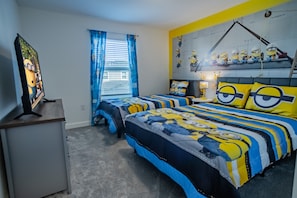 A bedroom with two beds, a desk, and a window with blue curtains. - 4BR Storey Lake Townhome, Heated Pool (Kissimmee)