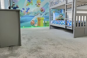 A bunk bed room with a mural of animated characters on the wall. - 5BR Storey Lake Home, Heated Pool (Kissimmee)