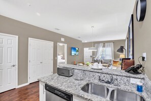 A modern kitchen with granite countertops, a dishwasher, and a sink. - 3BR West Lucaya Home Near Disney (Kissimmee)
