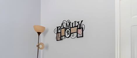 A minimalist room with a desk, chair, and a wall decoration.
