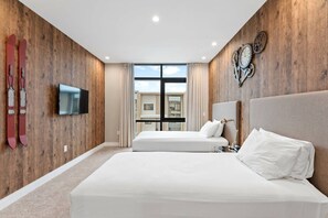 A hotel room with a wooden wall, a TV, two beds, and a window with curtains. - Magic Vilage Cozy Attractive 8min Disney (Kissimmee)