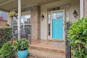 A house with a blue door, a brick exterior, and a porch with steps. - 5BR Masters Retreat ~ 10 min to Augusta National (Martinez)