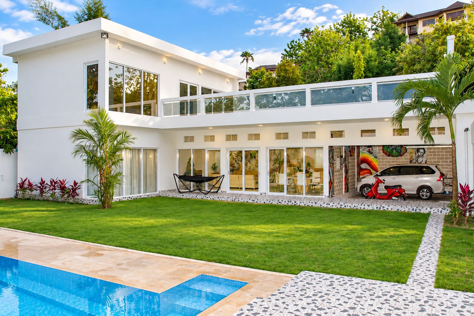 A modern two-story house with a swimming pool, a covered patio, and a mural on the exterior wall.