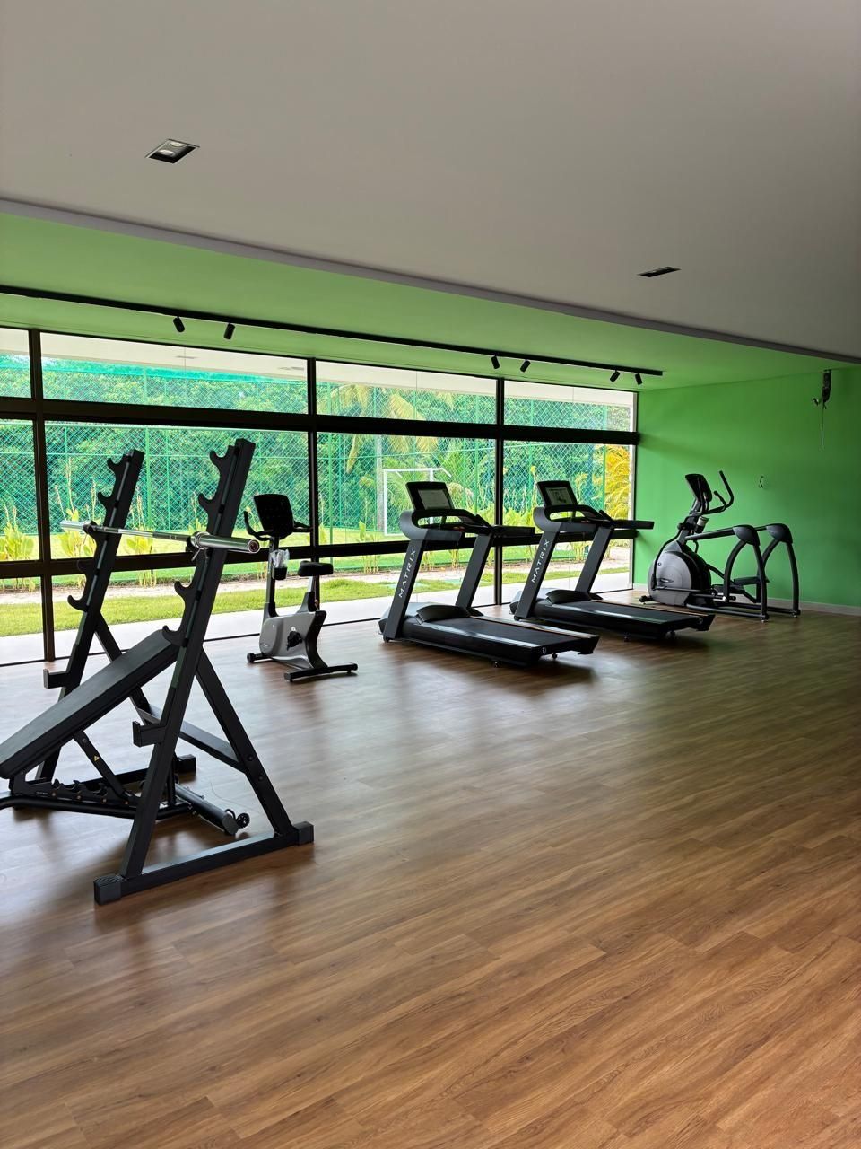 A gym with treadmills, ellipticals, and weight machines.