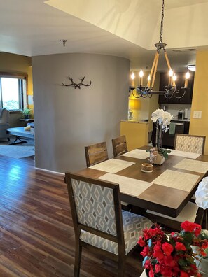 A dining area with a wooden table, chairs, and a chandelier. - Updated 6th -Floor Condo with Stunning Panoramic Grandfather Mountain View’s (Sugar Mountain)