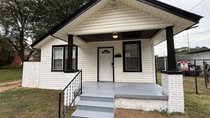 A single-story house with a front porch, a door, and a mailbox. - Portifino-Cozy on Charles (Montgomery)