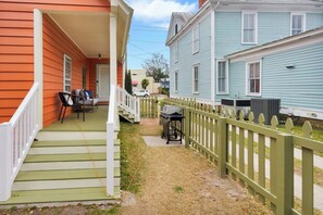 A residential property with a porch, outdoor seating, and a fenced yard. - Downtown New Bern 3-Bed Home - Yard, Pet-Friendly! (New Bern)