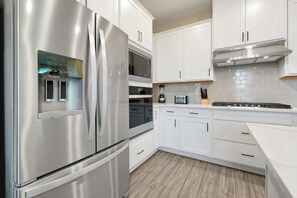 Modern Kitchen Appliances — Feel free to use the large French-door refrigerator, built-in microwave, and oven for all your dining needs. - New 5BR Reunion Villa, Themed Rooms, Resort Pools (Kissimmee)