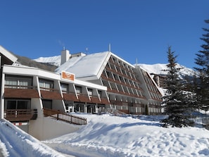 A hotel with a modern architectural design, featuring a sloped roof and multiple balconies. - Studio with south balcony - 4 guests (Saint-Chaffrey)