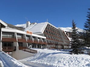 Ein Hotel mit moderner Architektur, mit geneigtem Dach und mehreren Balkonen.