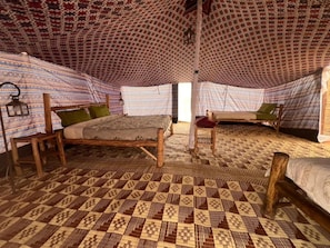 A room with two beds, each with a patterned canopy and a wooden frame. - Camp Rêve de Nomade (Lompoul)