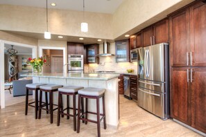 A modern kitchen with a central island, stainless steel appliances, and wooden cabinetry. - Inviting 4Br/4Ba executive home in desirable Larkspur Creekside neighborhood (Larkspur)