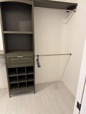 A walk-in closet with open shelving, a rod for hanging items, and a built-in shoe rack. - Winter Escape on the Water in Crystal River (Crystal River)