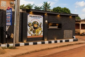 A small building with a sign for DIO Grazie Hotel, indicating it is a restaurant and hotel. - Diograzie Hotel (Benin City)