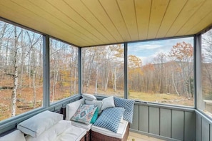 A covered porch with a view of a forested area. - Vermont Chalet 10 Min to Mount Snow - Fireplace, Game Room & Fire Pit, Sleeps 10 (Wilmington)
