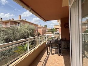 A balcony with a table and chairs, a railing, and a view of neighboring buildings. - L'oneta Mediterranean Charm by the sea (Javea)