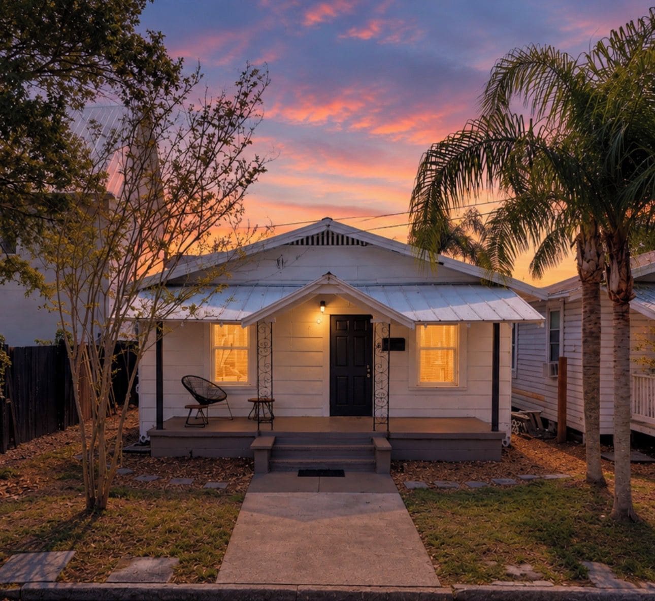 A single-story house with a front porch, a small entryway, and a visible mailbox.
