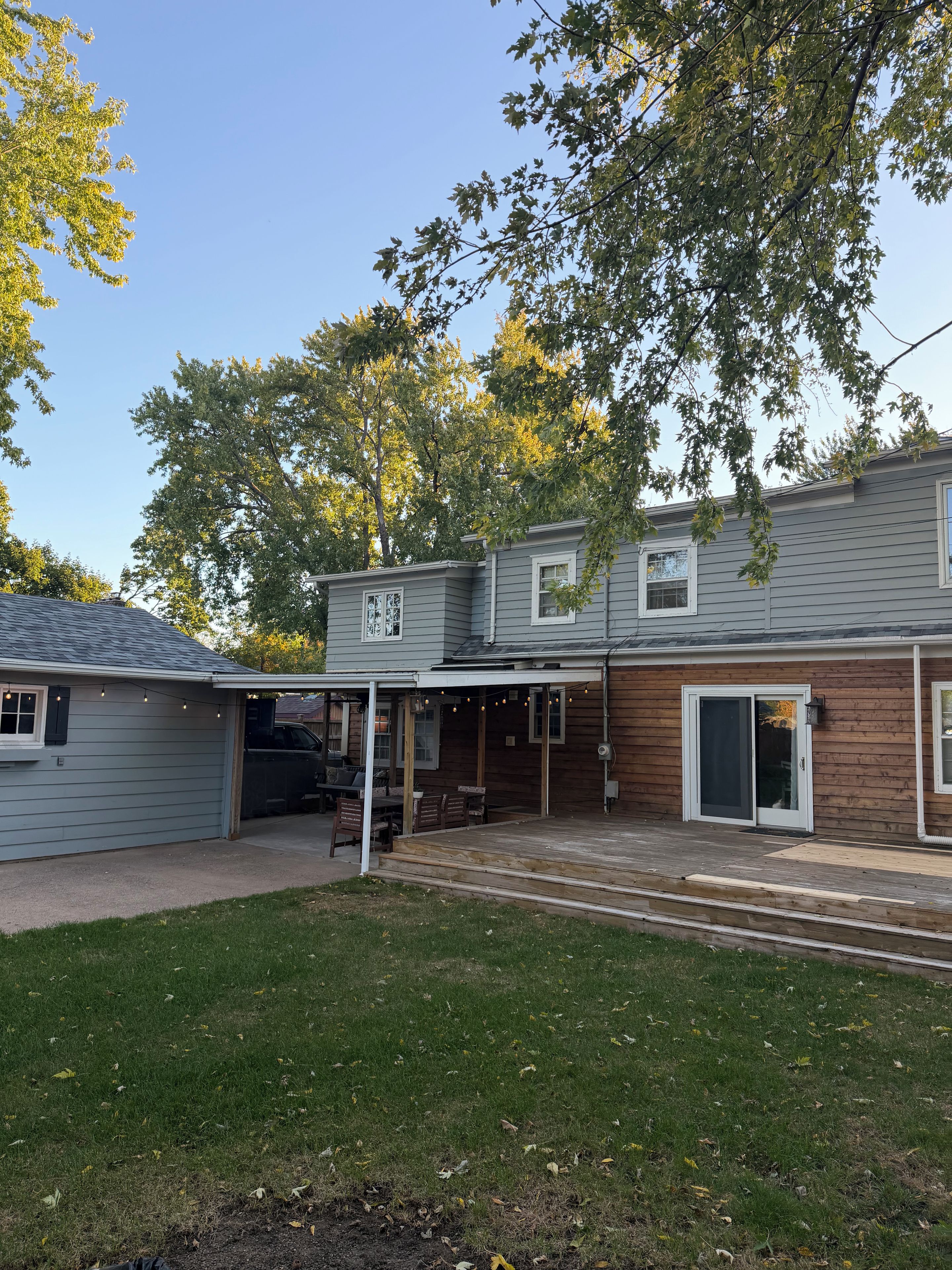 A two-story house with a covered patio and a garage.
