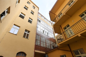 A multi-story building with a central staircase, multiple windows, and balconies. - Elegant Prague Apt•Wenceslas Square• City Center (Praha)