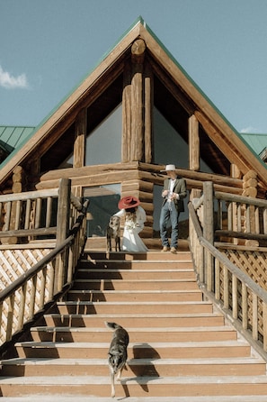 A wooden staircase leading to a lodge with a green roof. - Historic 5-bedroom log home in Choteau perfect for families or large groups (Choteau)