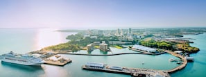A cruise ship docked at a port with a cityscape in the background. - Contemporary 1-bed Apartment Darwin CBD (Darwin)