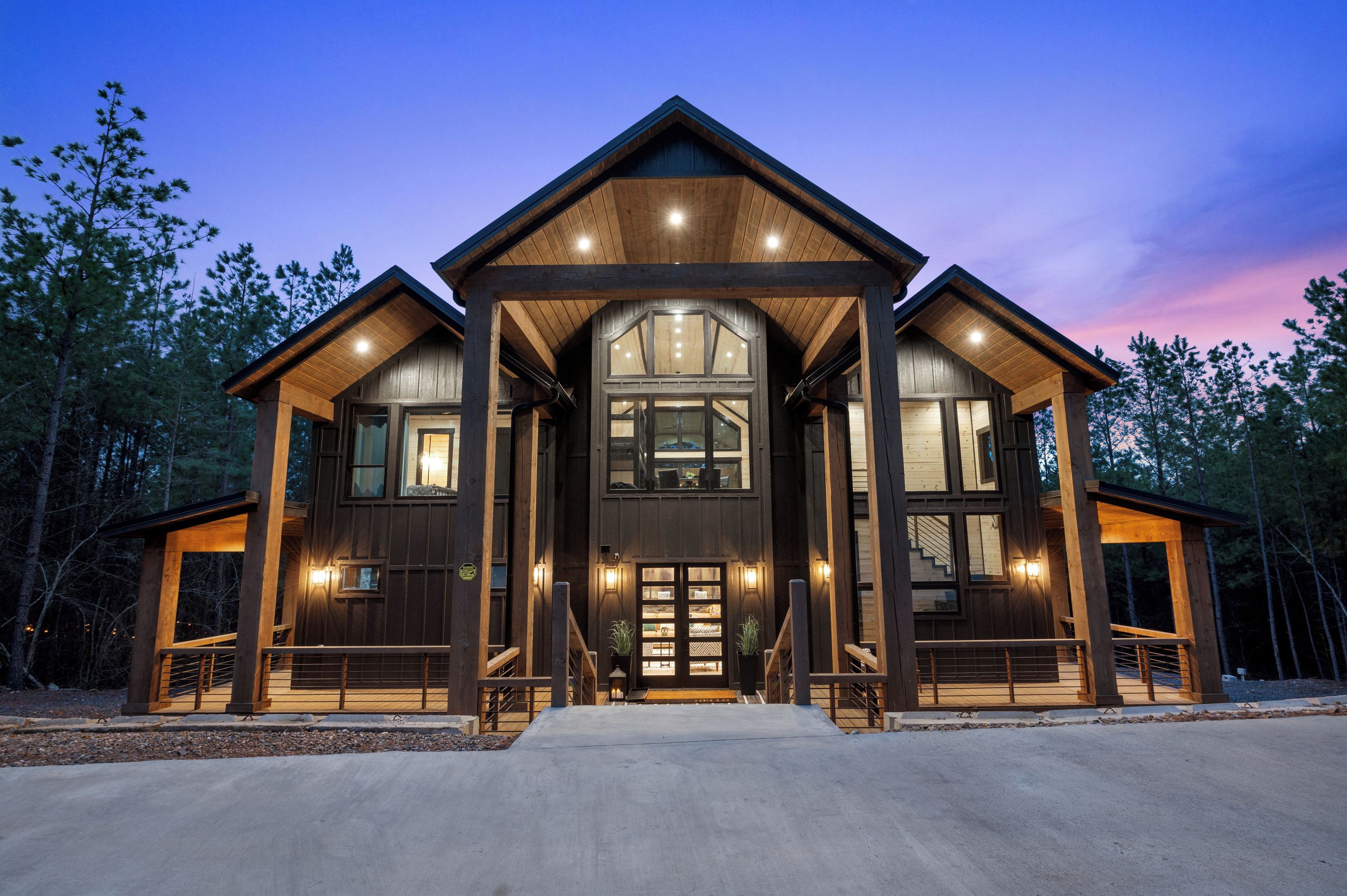 A large, two-story wooden house with a prominent front entrance and multiple windows.