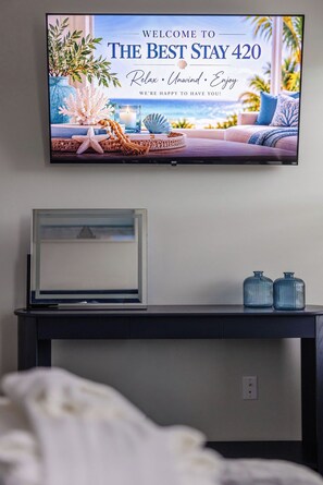 A television displaying a welcome message for 'The Best Stay 420' with a coastal view. - The Best Stay 420 - Cozy 4BR Home Near Savannah (Port Wentworth)