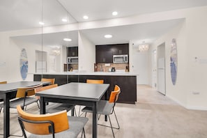 A modern kitchen with dark cabinets, a stainless steel microwave, and a white countertop. - Renovated Condo Near Omni La Costa Resort & Golf! (Carlsbad)