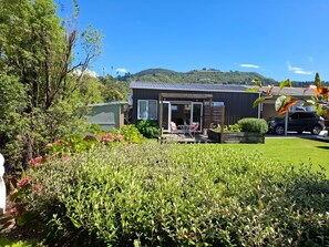 A residential property with a patio, a garage, and a garden.