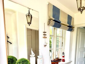 A room with a large window, a door, and a mirror reflecting the interior. - "living in the Countryside", HT 6 (Oldsum)