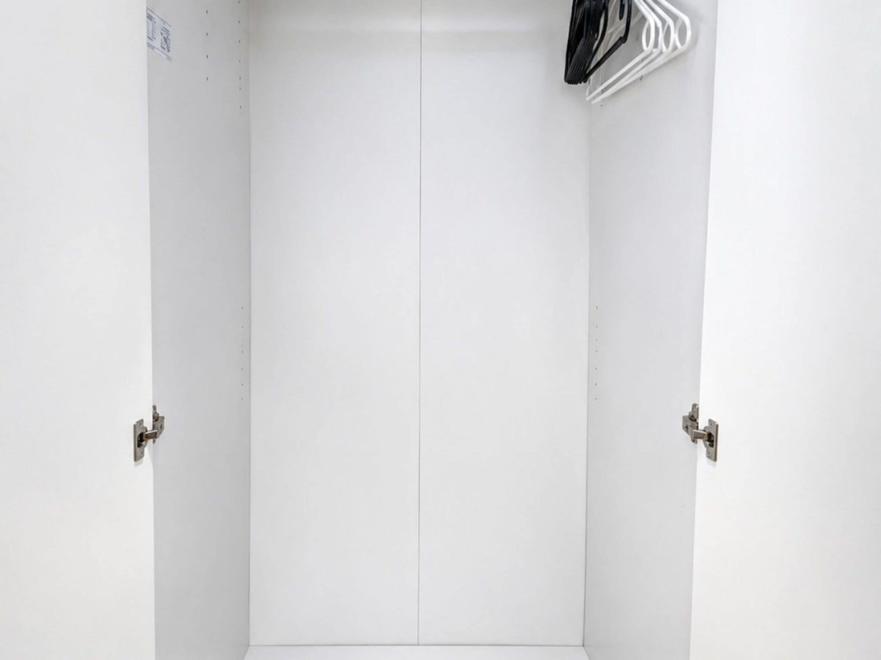 A white door with a simple latch mechanism.