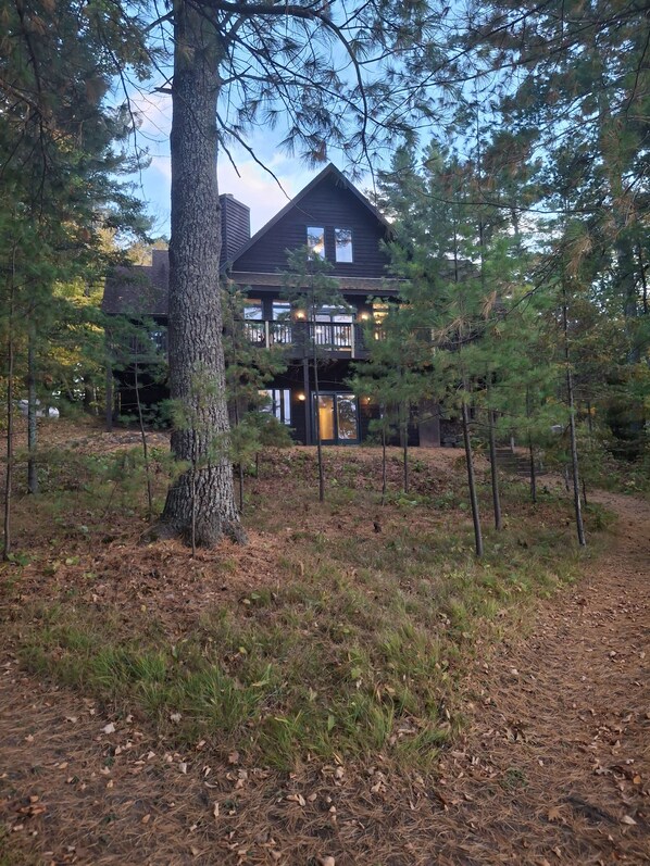 A two-story building surrounded by trees. - Spacious Lakehouse on Lac Courte Oreilles (Stone Lake)