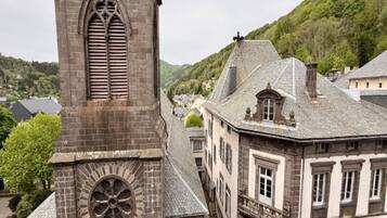 A historic building with a prominent clock tower and a narrow street.