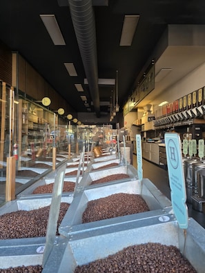 A coffee shop interior with multiple coffee bean dispensers and a visible coffee machine. - Quiet Sunlit Sanctuary, St Kilda | WiFi, Parking (Saint Kilda East)