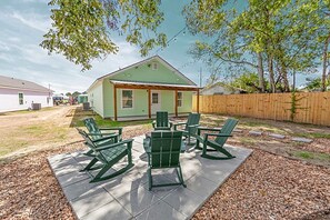 A backyard with a patio area, outdoor furniture, and a small house. - Baronne Inn•Pool Table•KING•Arcade•100”TV•Bar (Lafayette)