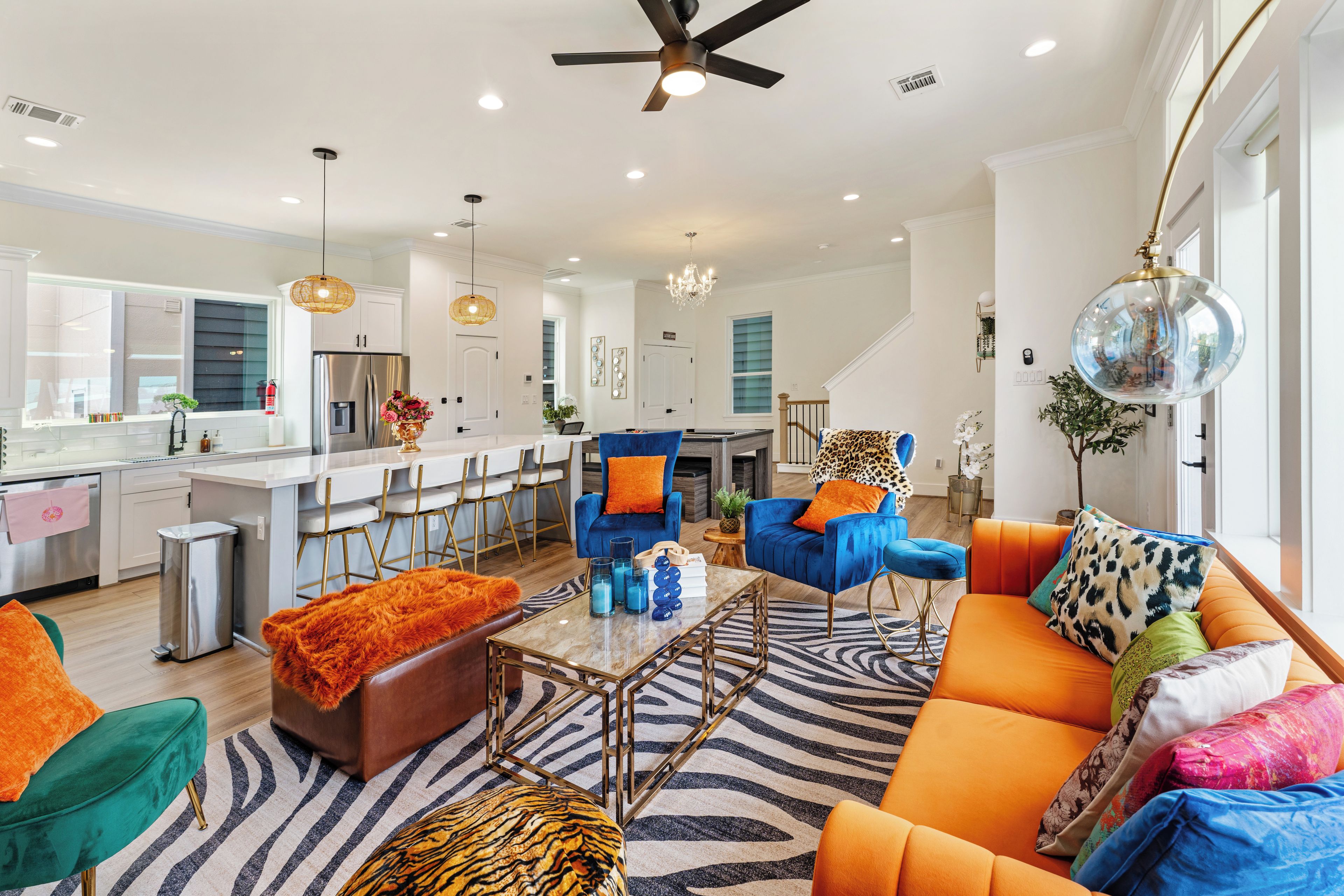 A modern living room with a sofa, chairs, and a coffee table.