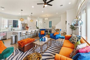 A modern living room with a sofa, chairs, and a coffee table. - Rooftop Cinema Under the Stars +  Prime Location (Houston)