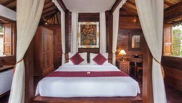 A wooden room with a bed, curtains, a window, and a nightstand.