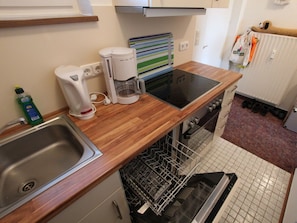 A kitchen with a stainless steel sink, a coffee maker, a toaster, and a dishwasher. - Holiday Apartment With 2 Bedrooms (Wyk auf Foehr)