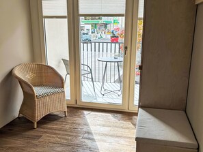 A room with a wicker chair, a small table, and a sofa. - Maloja Alpine Lodge by Interhome (Maloja)