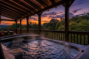 A hot tub under a wooden pergola with a view of a sunset and forested hills. - Sleeps 10, Game Room, Arcade, Hot Tub, Mountain Views, 6 Mi to Dollywood (Sevierville)